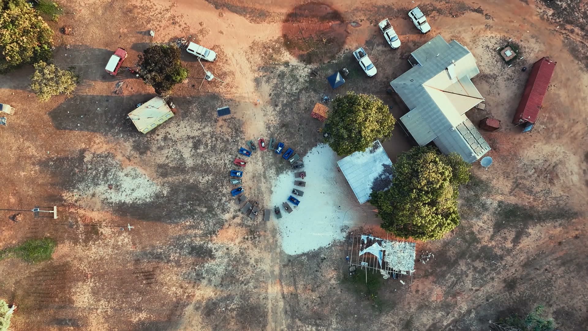 Maningrida, July 2026 — All forty beds laid out in a circle on the white sand at Gamardi.